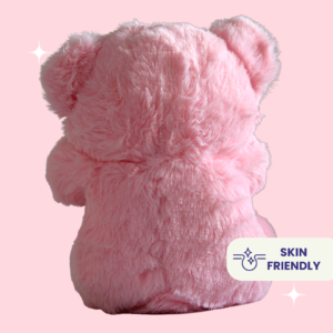 Cute pink teddy bear plush toy with a ribbon bow and a red heart